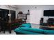 Bright living room features a teal couch, dining table, and built-in shelving at 855 E Church St, Deland, FL 32724