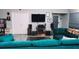 Living room boasts a large TV, home theater system, and teal sectional sofa at 855 E Church St, Deland, FL 32724