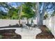Backyard featuring a white gravel seating area around a fire pit and surrounded by mature trees at 1146 Riverside Dr, Daytona Beach, FL 32117