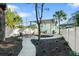 Landscaped backyard with a covered patio, seating area, white gravel, and lush greenery, perfect for outdoor gatherings at 1146 Riverside Dr, Daytona Beach, FL 32117