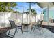 Backyard sitting area with chairs arranged around a firepit on a gravel bed, surrounded by a white fence at 1146 Riverside Dr, Daytona Beach, FL 32117