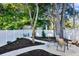 A charming backyard with white rock landscaping, a meandering pathway, and comfortable outdoor seating at 1146 Riverside Dr, Daytona Beach, FL 32117