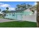 Charming single-story home featuring a light blue exterior, white garage door, and well-manicured front lawn at 1146 Riverside Dr, Daytona Beach, FL 32117