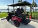 Comfortable golf cart seating with the community waterfront visible in the background, ready for relaxation at 1146 Riverside Dr, Daytona Beach, FL 32117