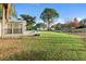 Large backyard with a shed, lush lawn, and water view at 2573 Delaware Rd, Deltona, FL 32738