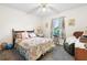Charming bedroom with floral bedding and a comfortable recliner at 2573 Delaware Rd, Deltona, FL 32738