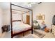 Spacious bedroom with a large four-poster bed and a sitting area at 2573 Delaware Rd, Deltona, FL 32738