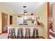 Kitchen boasts a breakfast bar with three stools and ample cabinetry at 2573 Delaware Rd, Deltona, FL 32738