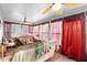 Peaceful sunroom, complete with wicker furniture and curtains at 2573 Delaware Rd, Deltona, FL 32738