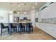 Bright kitchen featuring white cabinets, stainless appliances, tiled backsplash, and a center island with bar stools at 277 Cyan Ave, Daytona Beach, FL 32124