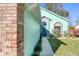 Teal house exterior with a blue door and brick accents at 3857 Long Grove Ln, Port Orange, FL 32129