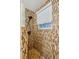 Walk-in shower with multi-toned tile and window at 404 S Beach St # 010 101, Daytona Beach, FL 32114