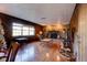 Gathering room with wood paneling, fireplace, and hardwood floors at 453 Merrimac Dr, Port Orange, FL 32127