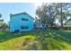 Light blue house with a large backyard at 453 Merrimac Dr, Port Orange, FL 32127