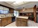 Wood kitchen cabinets, island, and adjacent dining space at 453 Merrimac Dr, Port Orange, FL 32127