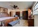 Main bedroom with large wood bed and dresser at 453 Merrimac Dr, Port Orange, FL 32127