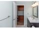 Updated bathroom with a dark vanity, light countertop and a view into the closet at 5178 Riverside Dr, Port Orange, FL 32127