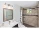 Bathroom featuring tile shower and dark wood vanity at 5178 Riverside Dr, Port Orange, FL 32127