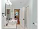Bright bathroom featuring white vanity, modern mirror, and decorative fixtures at 5178 Riverside Dr, Port Orange, FL 32127