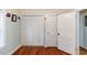 Bedroom with hardwood floors, a closet, and a doorway at 5178 Riverside Dr, Port Orange, FL 32127