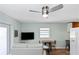 Living room area featuring white couch, television, table, and chairs at 5178 Riverside Dr, Port Orange, FL 32127