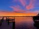 Scenic waterfront view with a wooden dock at sunset at 5178 Riverside Dr, Port Orange, FL 32127