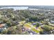 Scenic aerial shot of a residential neighborhood nestled among lush trees, with a lake view in the distance at 7360 Canal Dr, Sanford, FL 32771