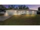 Charming single-story home with a well-manicured lawn, garage, and inviting front entrance at 7360 Canal Dr, Sanford, FL 32771
