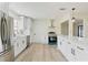 Bright kitchen featuring stainless steel appliances, white cabinets, and light wood flooring at 7360 Canal Dr, Sanford, FL 32771