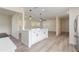 Bright, open kitchen featuring a center island with white cabinetry, modern fixtures, and stainless steel appliances at 7360 Canal Dr, Sanford, FL 32771