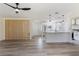 Open-concept living space showcasing wood flooring, a wood slat divider, and contemporary ceiling fan at 7360 Canal Dr, Sanford, FL 32771