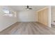 Spacious living room with ceiling fan, wood floors and large window for ample natural light at 7360 Canal Dr, Sanford, FL 32771