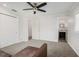 Bright bedroom with ceiling fan, carpet, and access to a full bathroom at 1275 Elkcam Blvd, Deltona, FL 32725