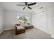Cozy bedroom featuring a brown couch, ceiling fan, and ample closet space at 1275 Elkcam Blvd, Deltona, FL 32725