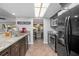 Modern kitchen with dark cabinetry, granite counters, and stainless steel appliances at 1275 Elkcam Blvd, Deltona, FL 32725