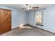 Simple bedroom featuring a window, ceiling fan and grey carpet at 1391 San Carlos Ave, Deltona, FL 32738
