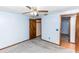 Bright bedroom with ceiling fan and grey carpeting at 1391 San Carlos Ave, Deltona, FL 32738