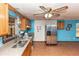 Galley style kitchen with stainless steel appliances and tile floor at 1391 San Carlos Ave, Deltona, FL 32738