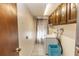 Laundry room with washer, dryer, and ample cabinet space at 1391 San Carlos Ave, Deltona, FL 32738