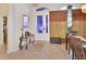 Charming foyer featuring a decorative glass door, elegant table, and neutral tile flooring at 151 Saddlebrook Way, Deland, FL 32724