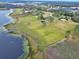 Aerial view highlighting lakefront lot with dock and buildings at 180 Robinson Ln, Seville, FL 32190