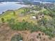 Aerial view of lakefront property with home and expansive acreage at 180 Robinson Ln, Seville, FL 32190