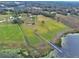 Aerial view of property with lake access and dock at 180 Robinson Ln, Seville, FL 32190