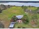 Aerial view of a home on a large lot with lake access at 180 Robinson Ln, Seville, FL 32190