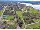 Aerial view showing property location near road and lake at 180 Robinson Ln, Seville, FL 32190