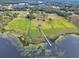 Aerial view of property showing lakefront access and dock at 180 Robinson Ln, Seville, FL 32190