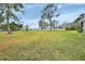 Large grassy backyard with waterfront views and mature trees at 180 Robinson Ln, Seville, FL 32190