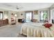 Peaceful bedroom with a queen bed, dresser, and patio access at 180 Robinson Ln, Seville, FL 32190