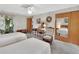 Bedroom with twin beds, dresser, and mirrored closet doors at 180 Robinson Ln, Seville, FL 32190