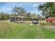 Covered carport parking for two vehicles, in a grassy area at 180 Robinson Ln, Seville, FL 32190